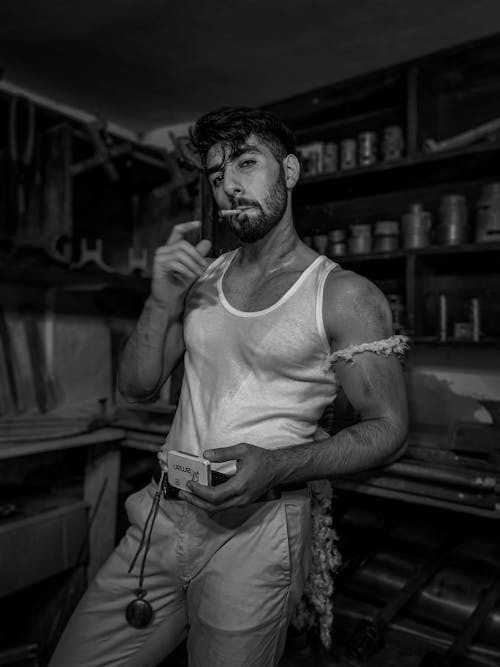 Man Smoking Cigarette in Workshop