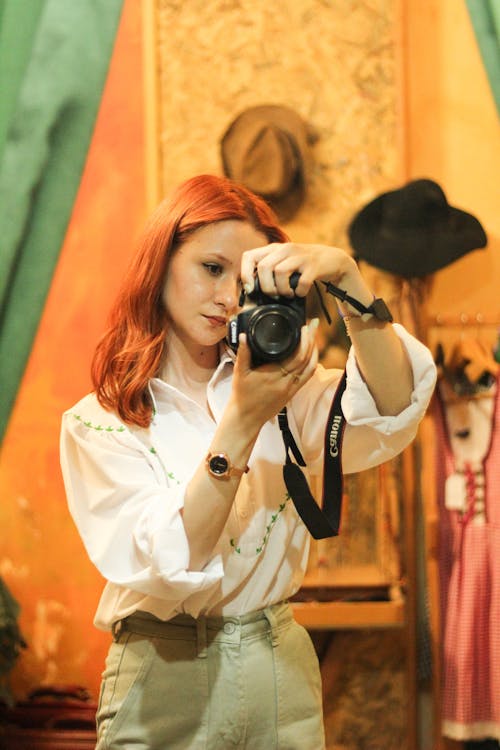 Free Redhead Woman Standing with Camera Stock Photo