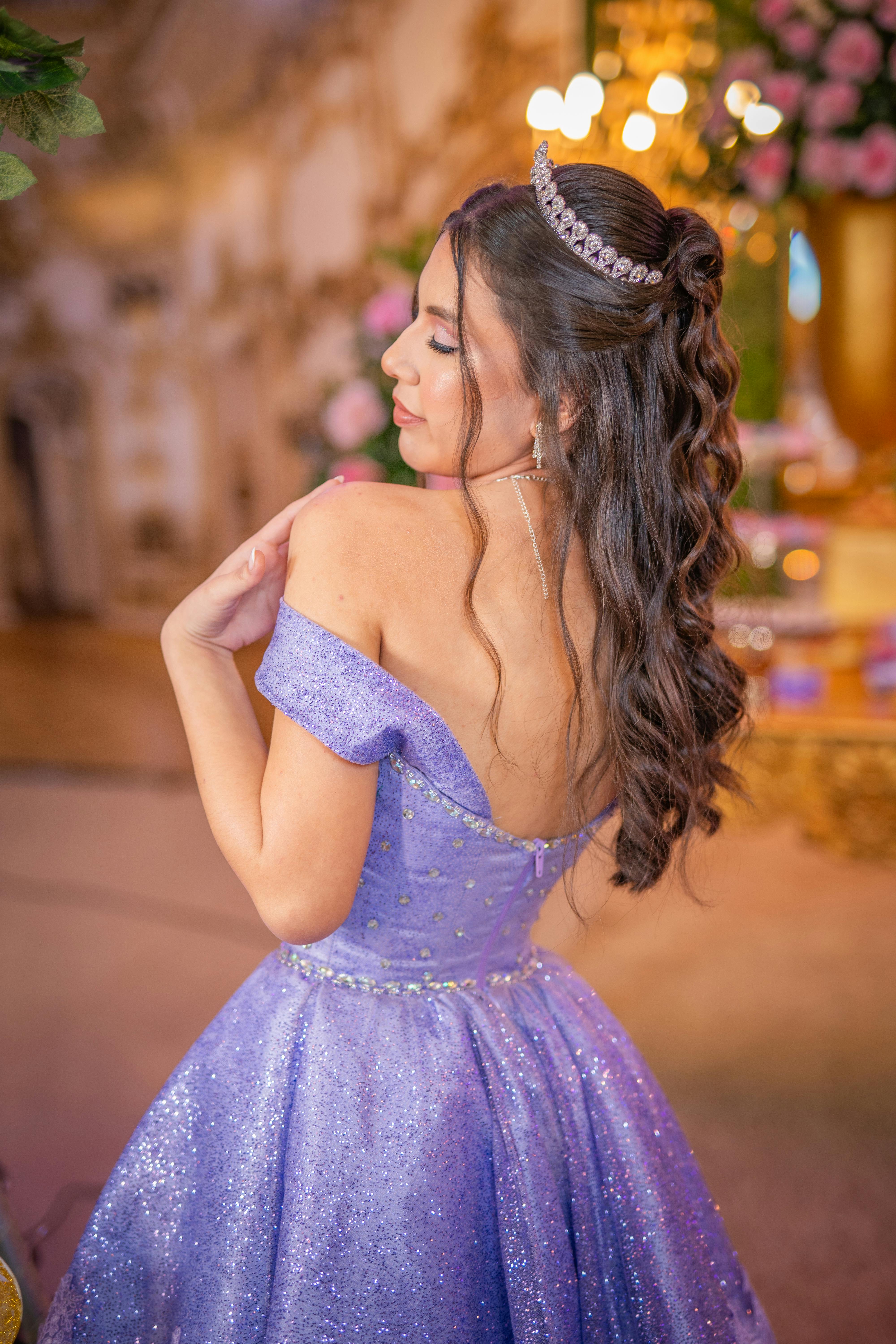 quinceanera posing in a purple dress