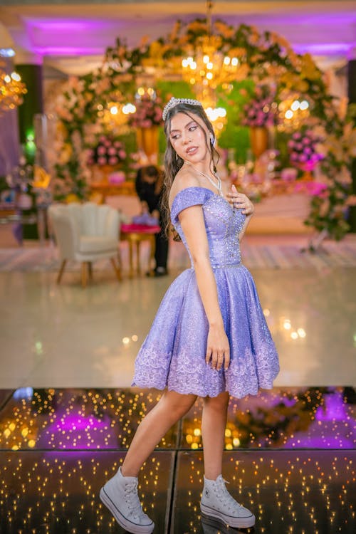 Quinceañera Posing in a Purple Dress and White Trainers