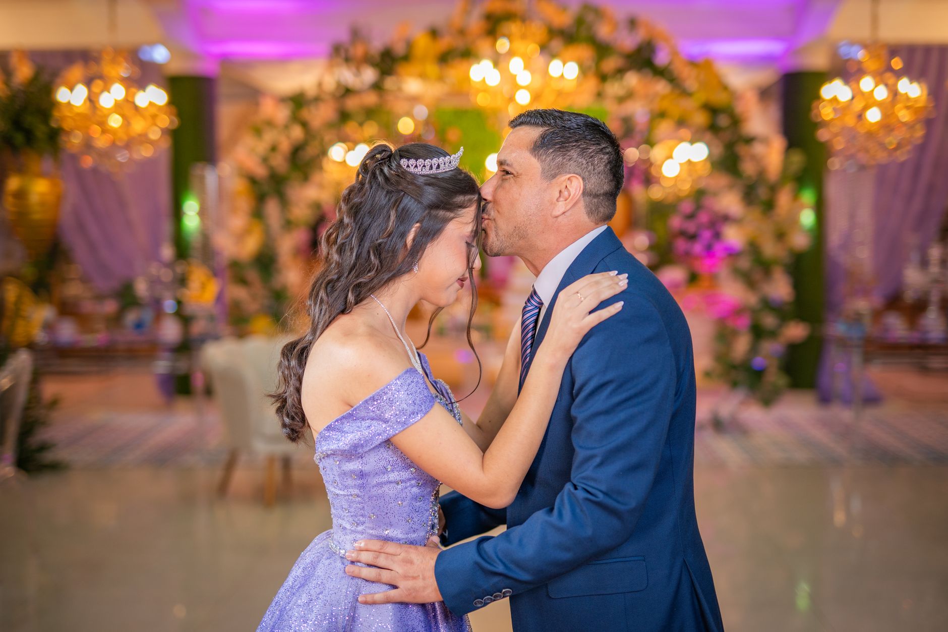 A father and daughter share a touching moment during her quinceañera dance.