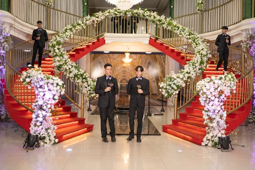 Men in Black Suits Standing near and on Stairs