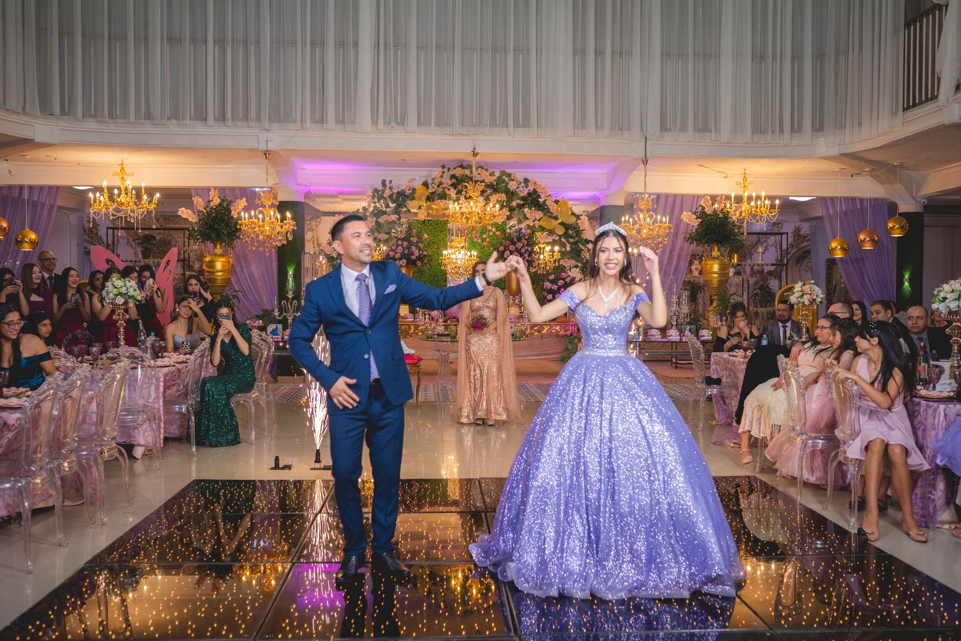 Elegant wedding ceremony showcasing a couple dancing amidst a festive reception with guests.
