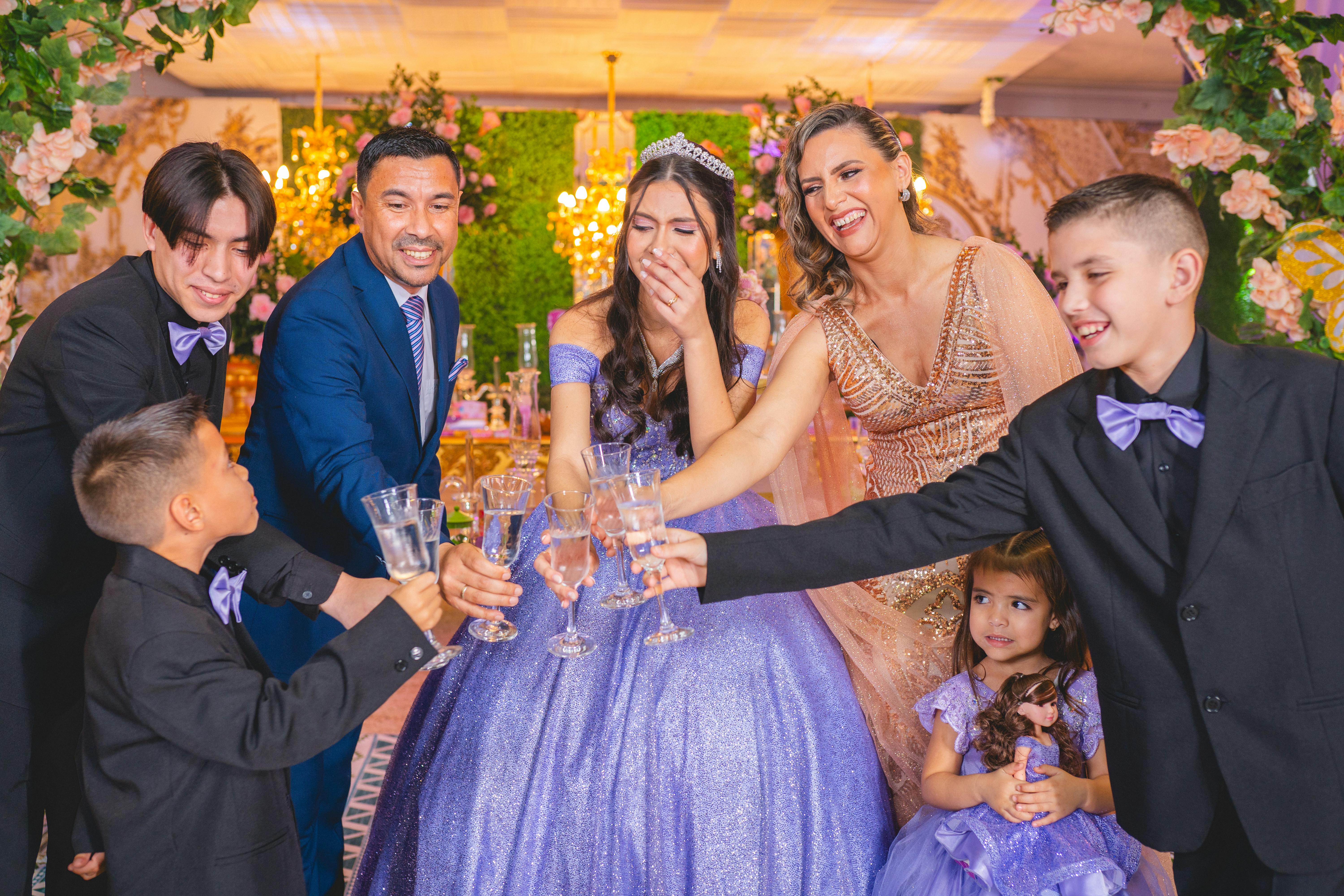 a girl making a toast with her family at her birthday party