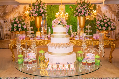 A Birthday Cake and Flower Arrangements in a Reception Hall 