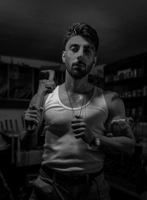 Black and White Portrait of a Man with Metal Tool 