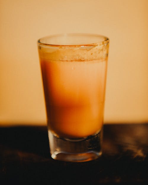 Close-up of a Shot Glass with Orange Liquid