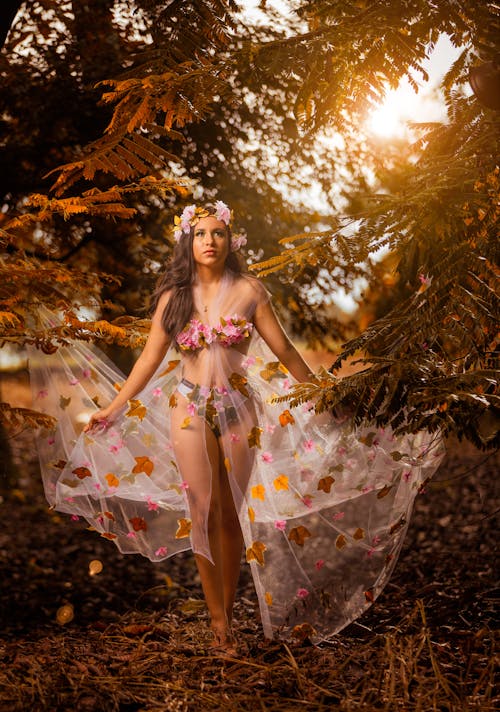 Photo of a Woman Wearing a Semitransparent Dress with Leaves