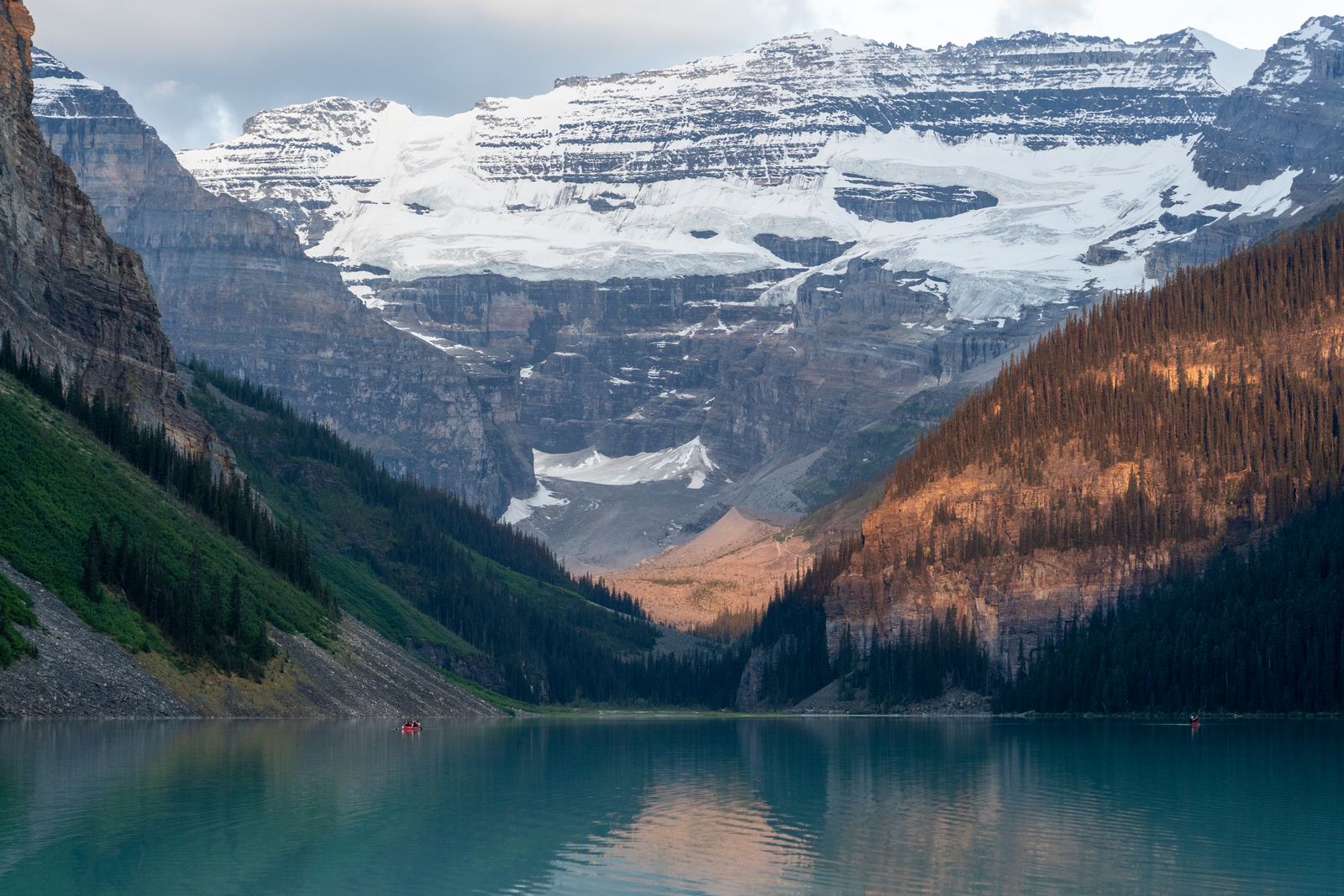 Lake Louise turquoise water framed by evergreen forest and snowcapped peaks in Banff National Park