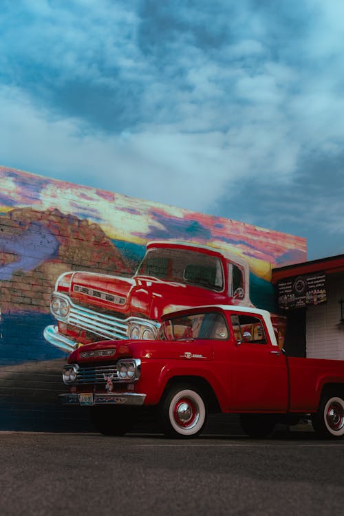 Photo of a Red Car and a Mural