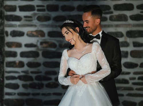 Smiling Newlywed Couple in Wedding Clothing