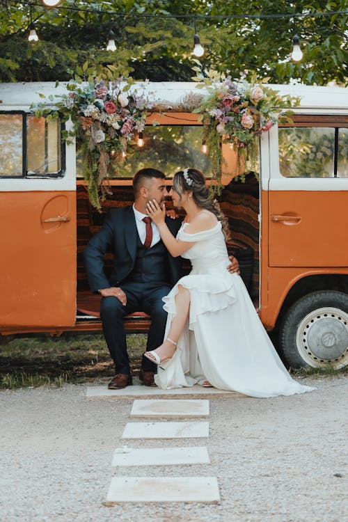 Newlyweds Sit in Back of Mini Van