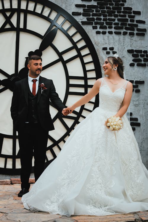 Smiling Newlyweds Holding Hands