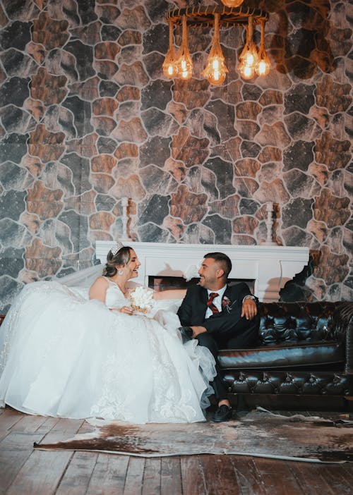 Happy Newlyweds Sit in Sofa