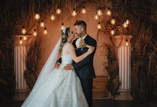 Newlyweds Standing between Columns