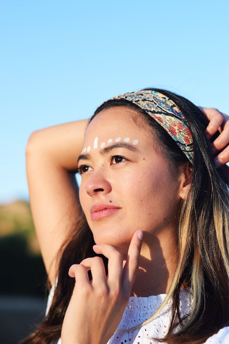 Woman With White Dots Painted On Forehead