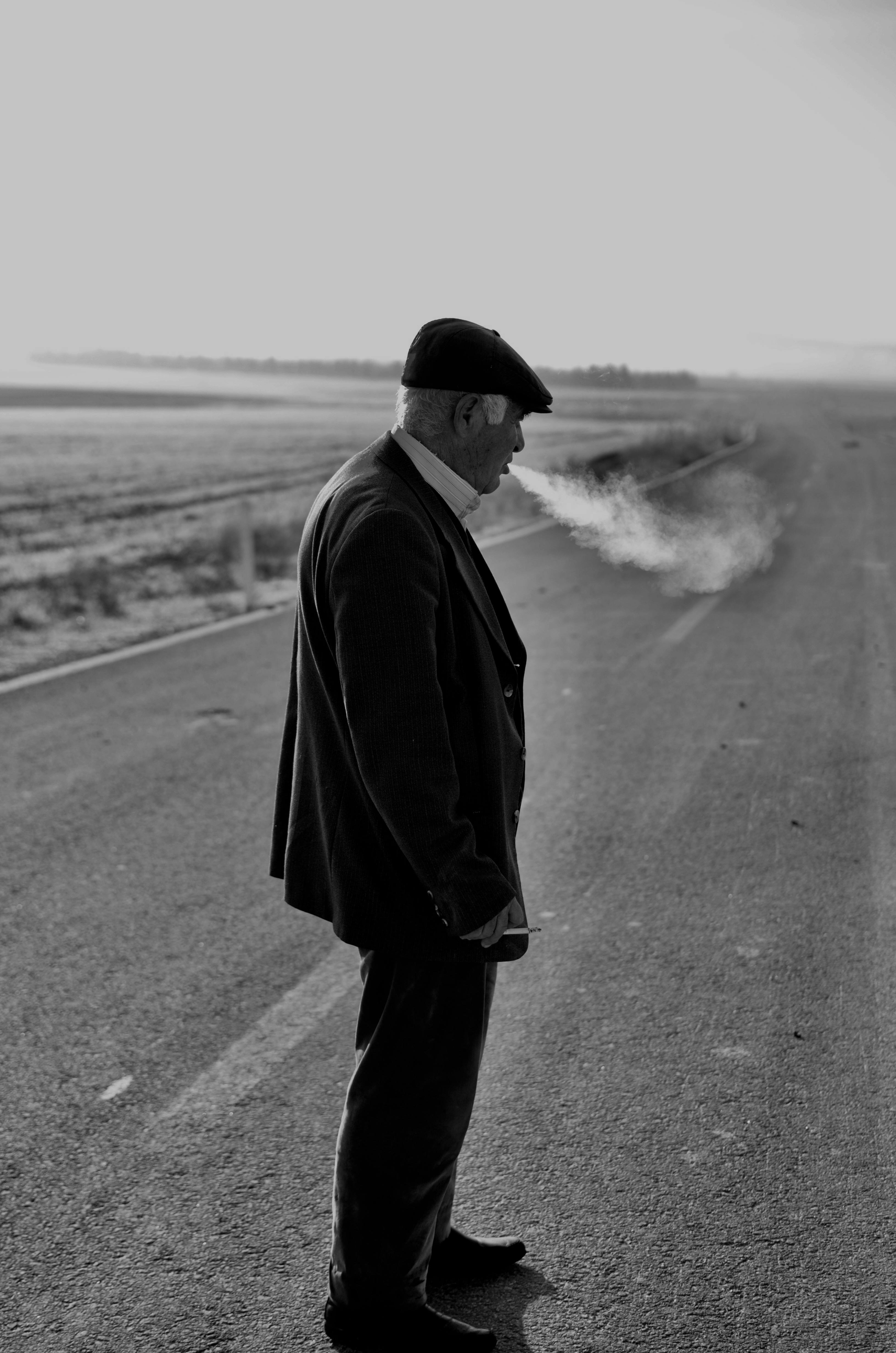 Man Standing and Smoking on Road · Free Stock Photo Man Standing and Smoking on Road · Free Stock Photo