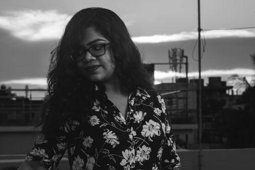 Free Stylish portrait of a woman with long hair and eyeglasses outdoors in black and white. Stock Photo
