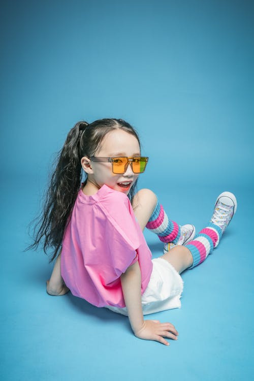 Girl Sitting in Sunglasses and with Long Hair
