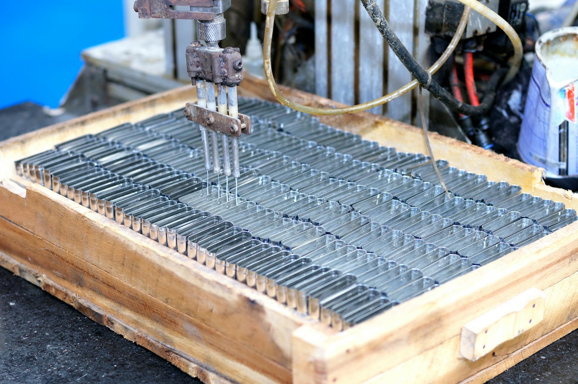 Close-up of an automated machine processing metal parts in an industrial setting.