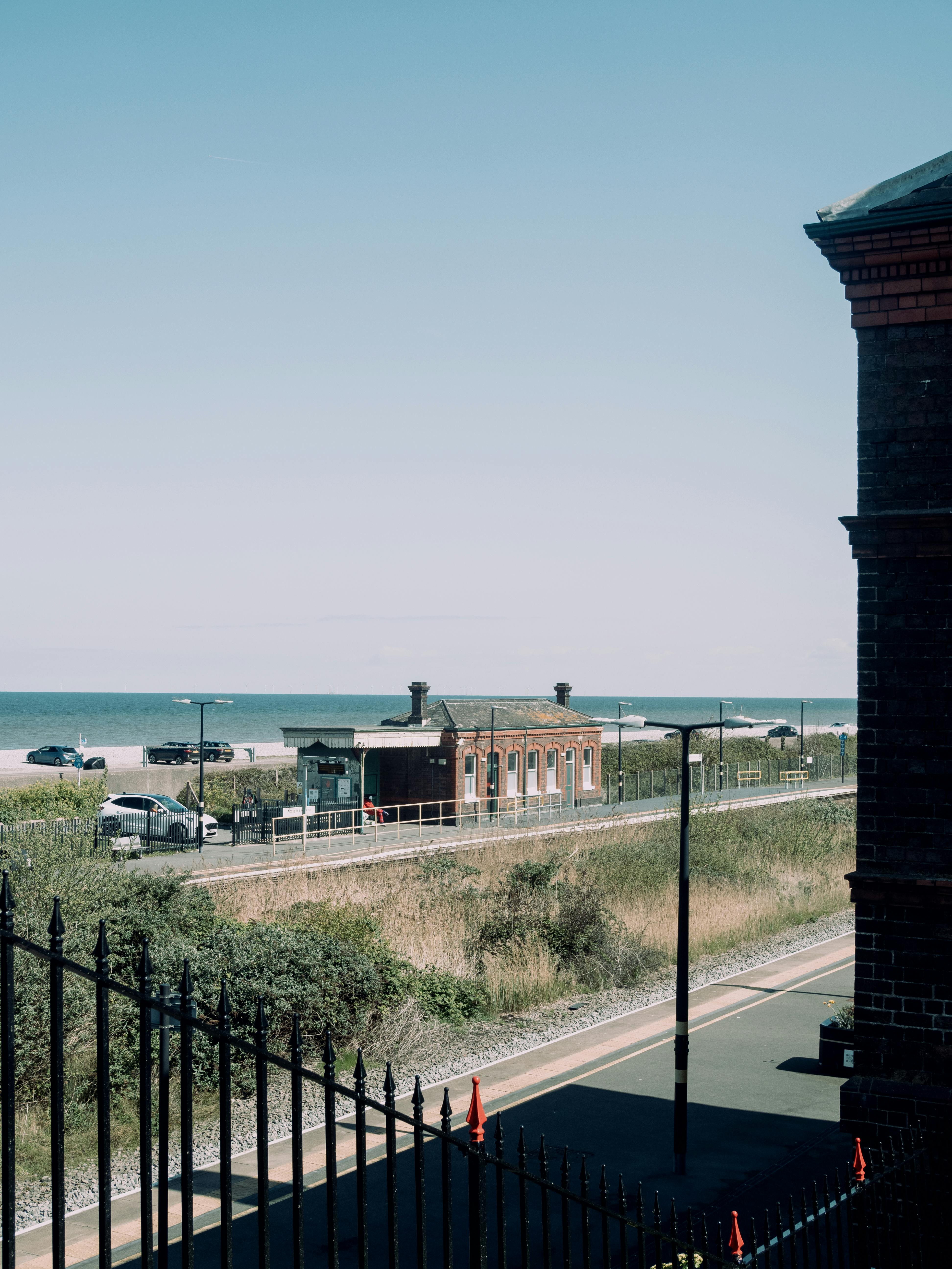 Abergele railway station near the coast in Wales with a clear summer sky.