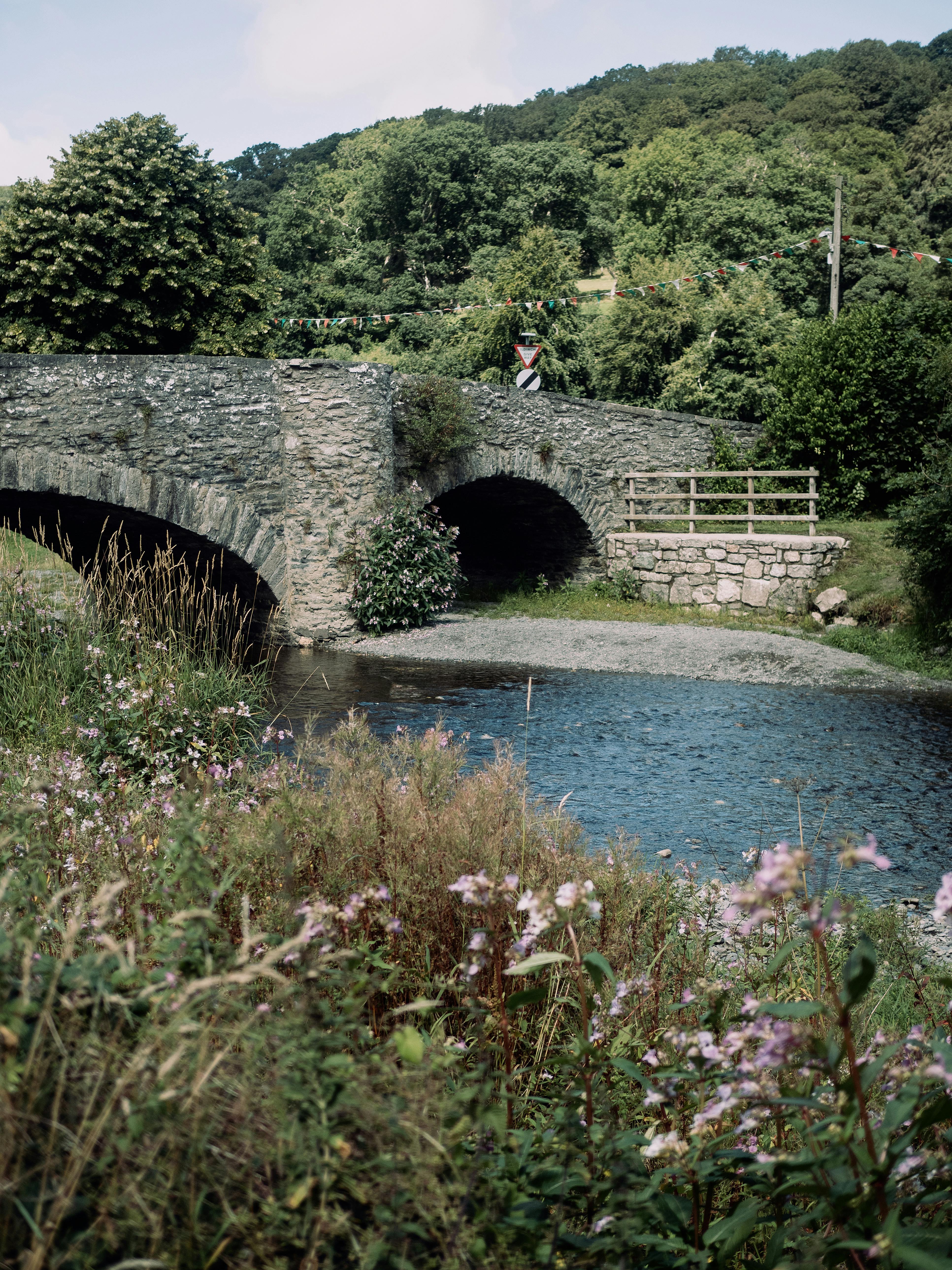 Charming stone bridge over a river in Llanfair Talhaiarn, Wales.