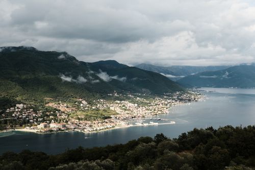 Free Breathtaking aerial view of a coastal town in Montenegro surrounded by lush mountains and the Adriatic Sea. Stock Photo