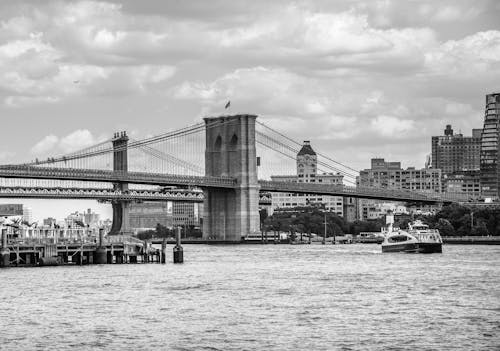 Black and White Photo of the Brooklyn Bridge over the East River between Manhattan and Brooklyn in New York City