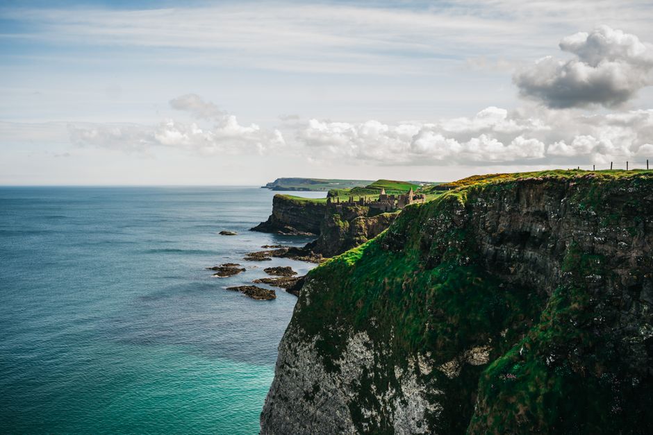 Hikers enjoying the view at the Cliffs of Moher, Ireland, highlighting adventure sports coverage