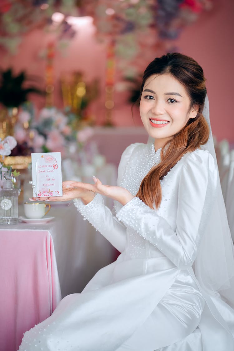 Bride Holding Invitation In Hand