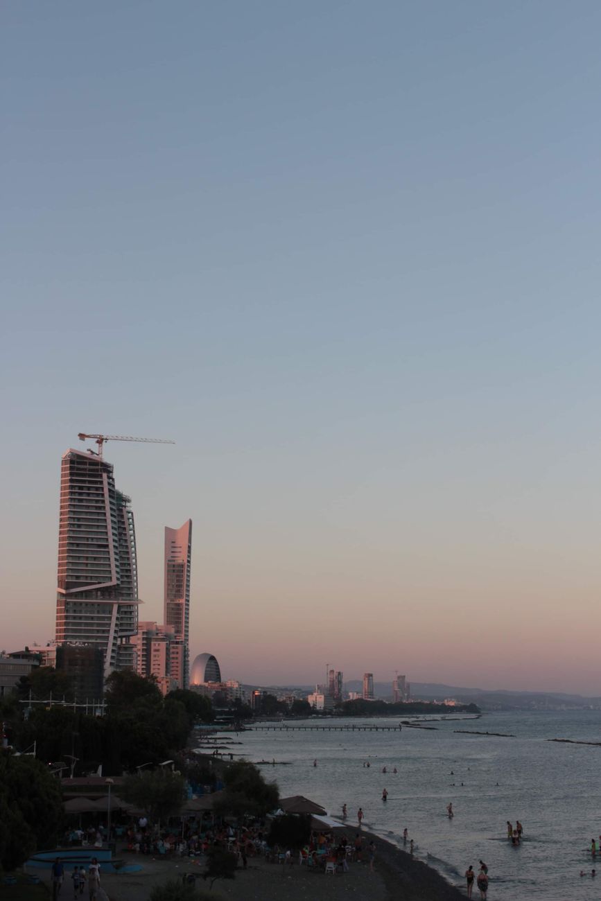 Limassol's coastal skyline by the sea at sunset in Cyprus.