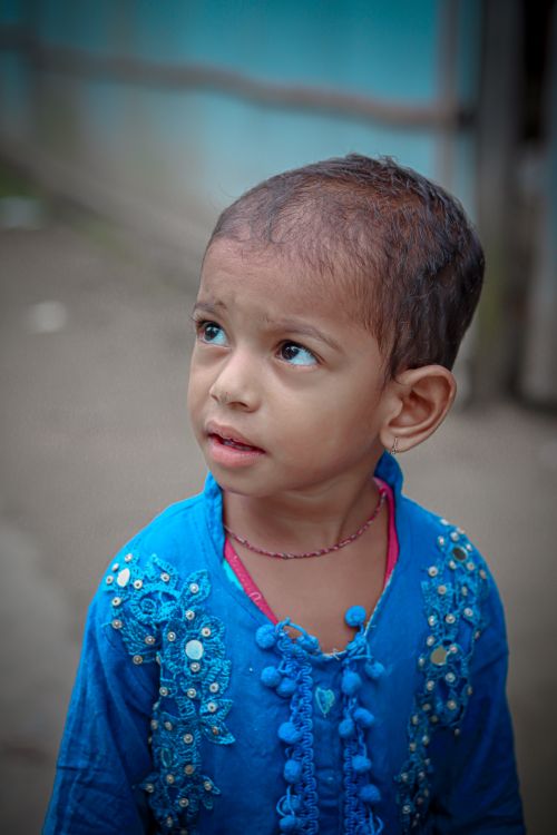Free Portrait of a young child in colorful traditional clothing, looking curious. Stock Photo