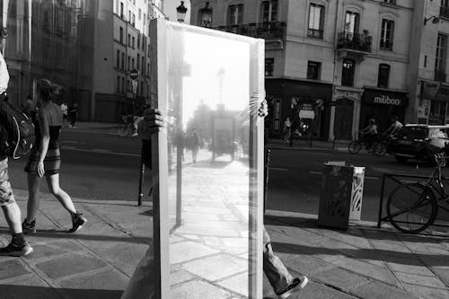 Person Walking with Mirror on Street
