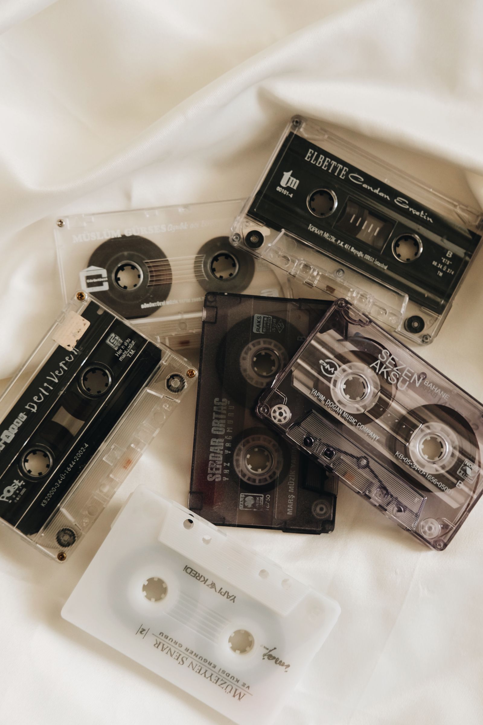 Collection of cassette tapes on white cloth