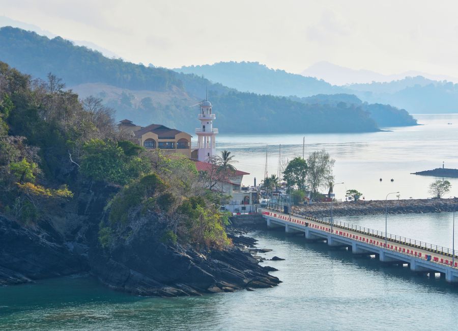 Serene view of Langkawi's coastline featuring a lighthouse and scenic landscape.
