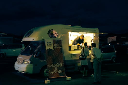 A bustling food truck in Kyoto serves customers during a vibrant night scene.