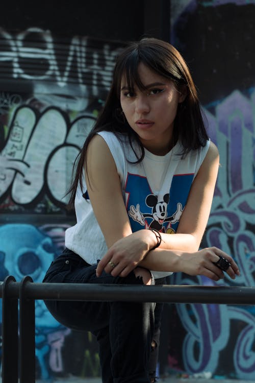 Woman Posing in White T-Shirt with Cartoon Print and Black Jeans