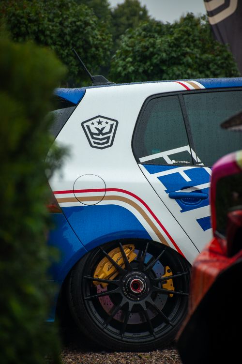 Free Close-up of a vibrant sports car with distinctive racing decals in an outdoor setting. Stock Photo