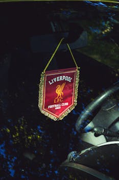 Liverpool FC pennant hanging inside a car, reflecting passion for football.