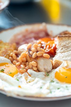 Enjoy a mouthwatering Full English breakfast with eggs, sausage, beans, and toast.