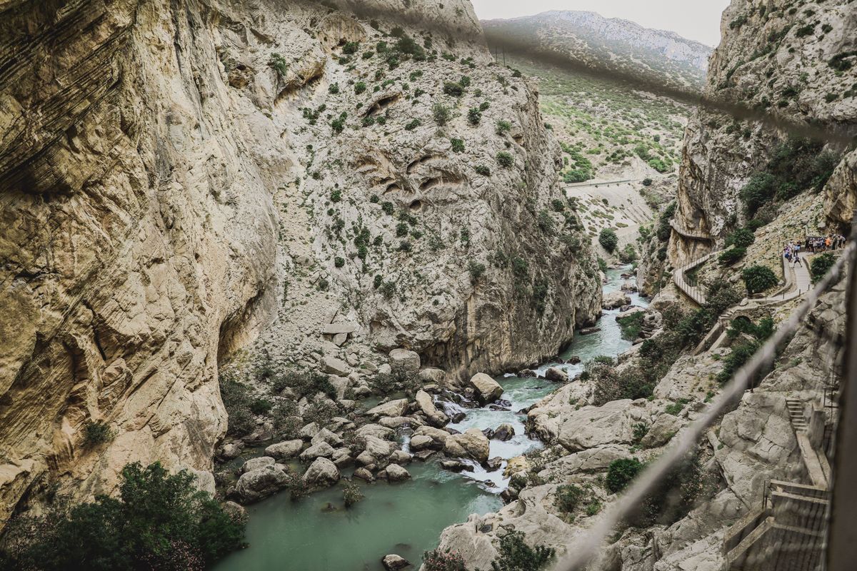 Hikers on the Caminito del Rey walkway above the gorge in Malaga, Spain
