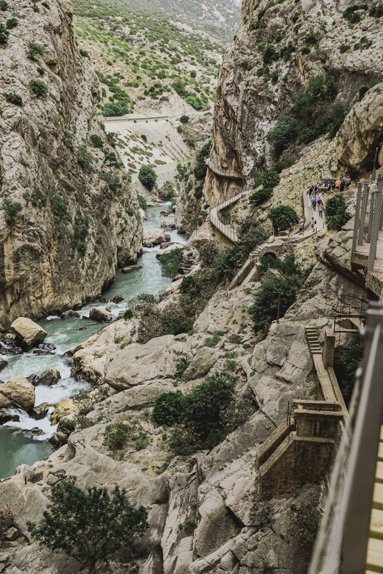 Group Of People Walking On A Narrow Path In A Canyon, Caminito Del Rey, Malaga, Spain