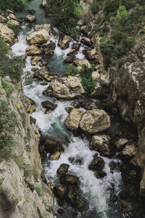 Free A flowing river navigating through rugged rocks in a picturesque Spanish landscape. Stock Photo