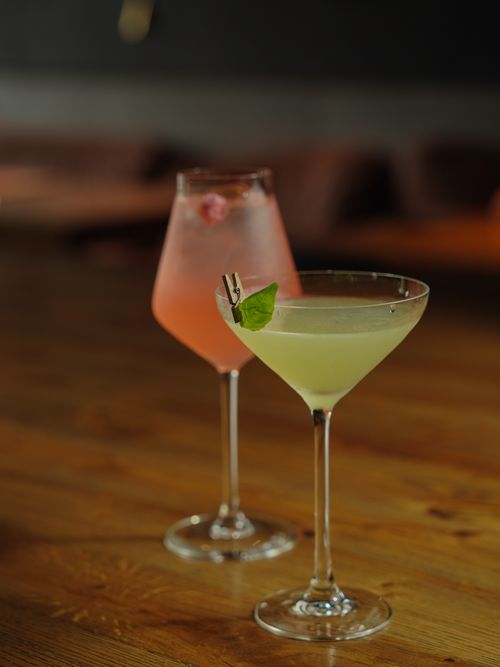 Free Two elegant cocktails beautifully presented on a rustic wooden table, perfect for nightlife and leisure. Stock Photo
