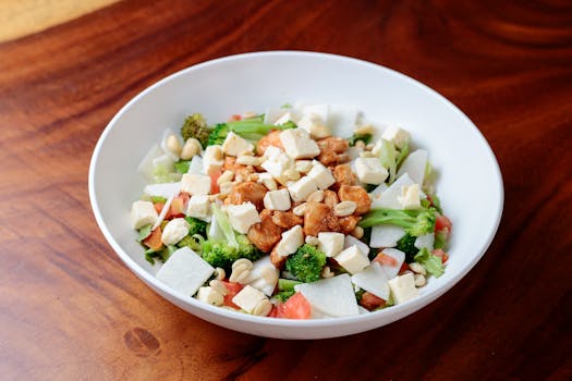 Delicious salad with tofu, broccoli, and peanuts in a bowl. Perfect for healthy dining.