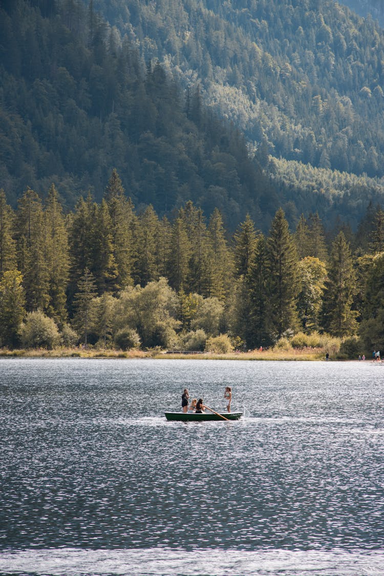 Tourists Rowing A Boat On The Lake