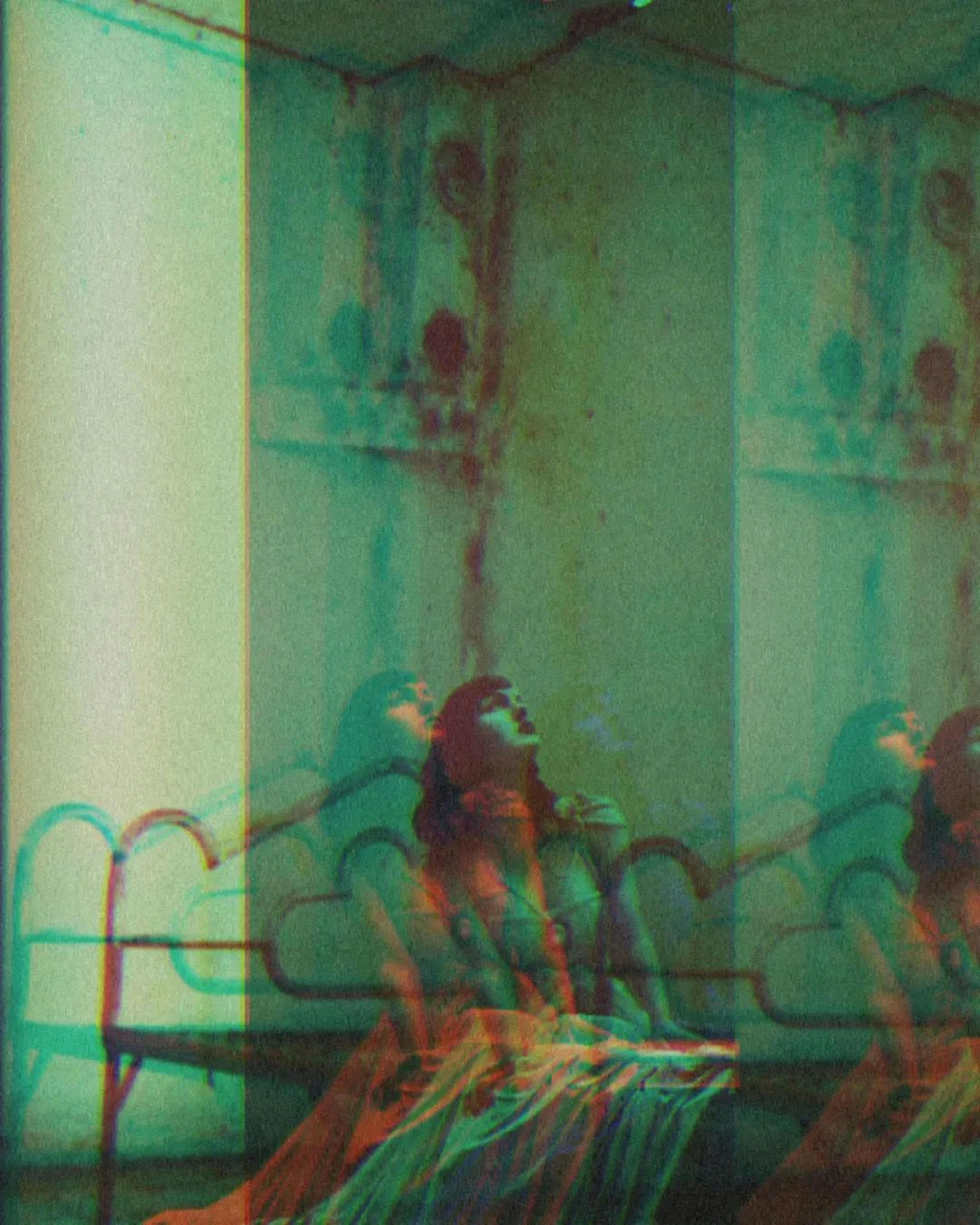 An artistic and abstract depiction of a woman seated indoors with a dreamlike, blurred effect.