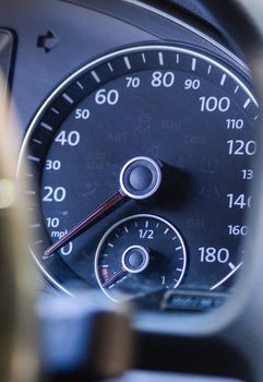 Detailed view of a car dashboard featuring a speedometer and fuel gauge.