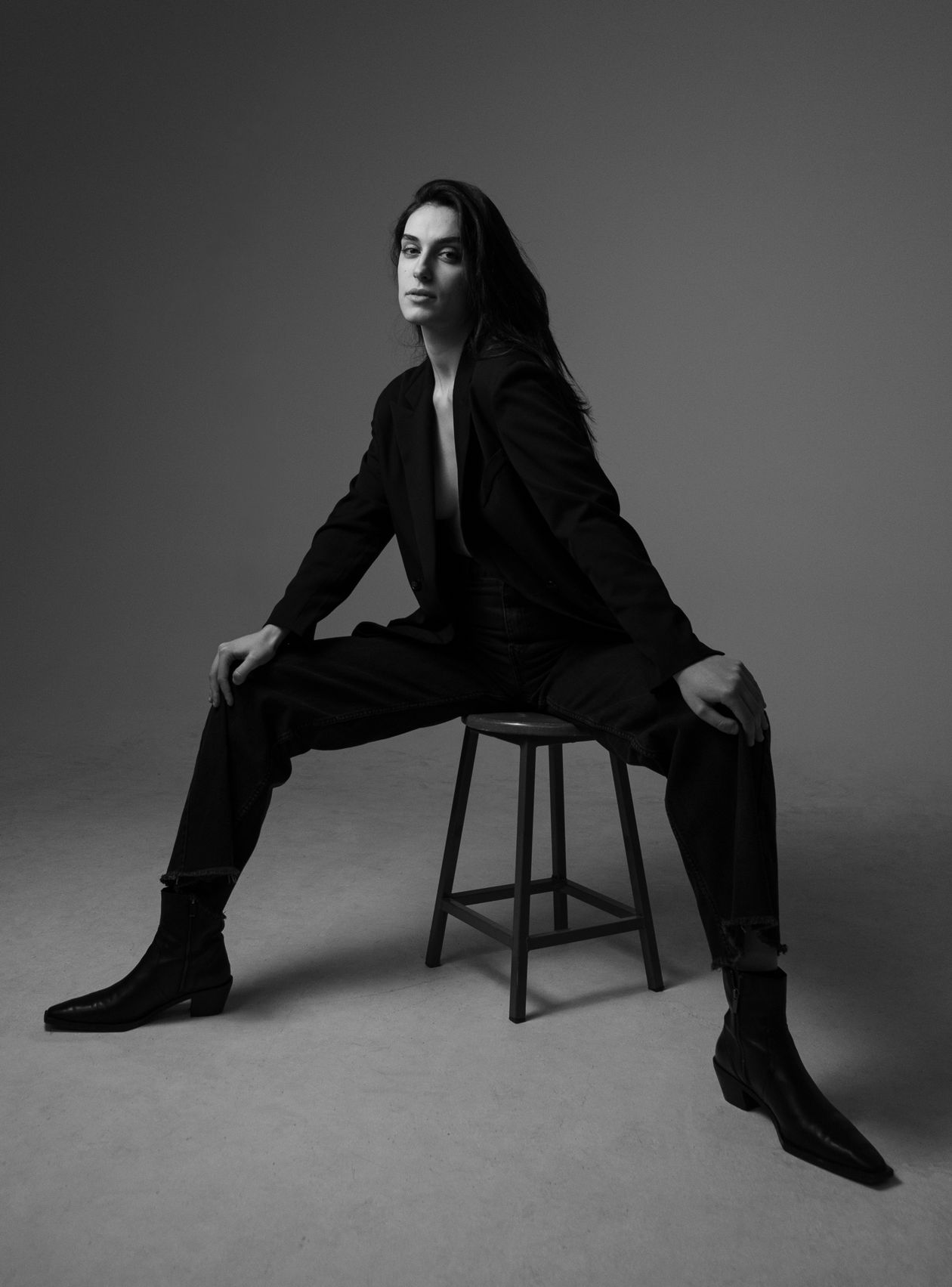 Black-and-white studio shot of cropped jeans with pointed black ankle boots