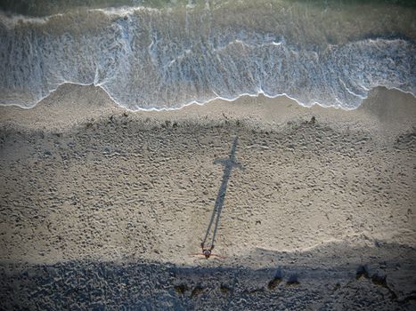 Shadow of Person Standing on Beach
